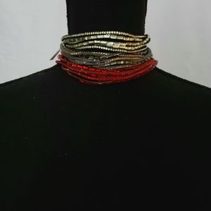 3 chokers or bracelets. Black, Gray and red.